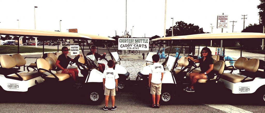 4 White golf carts facing each other image