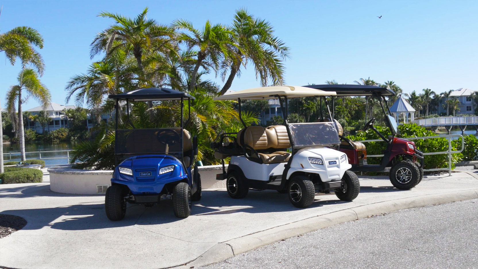 Three golf carts on sidewalk image