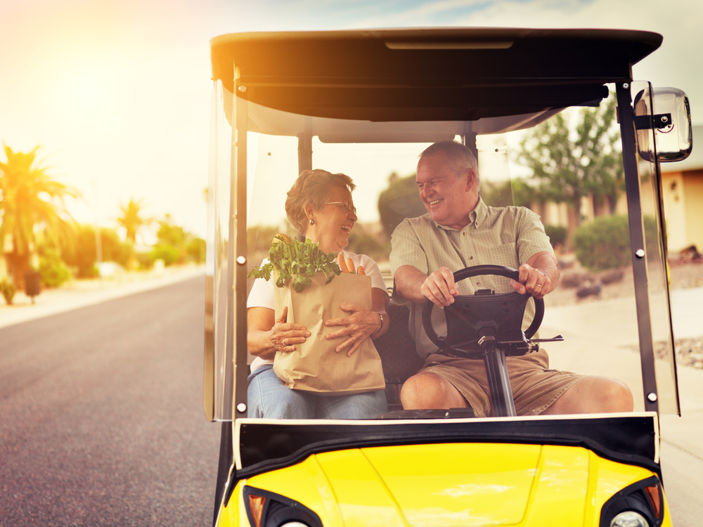elderly couple in golf cart, buy or rent golf carts in swfl