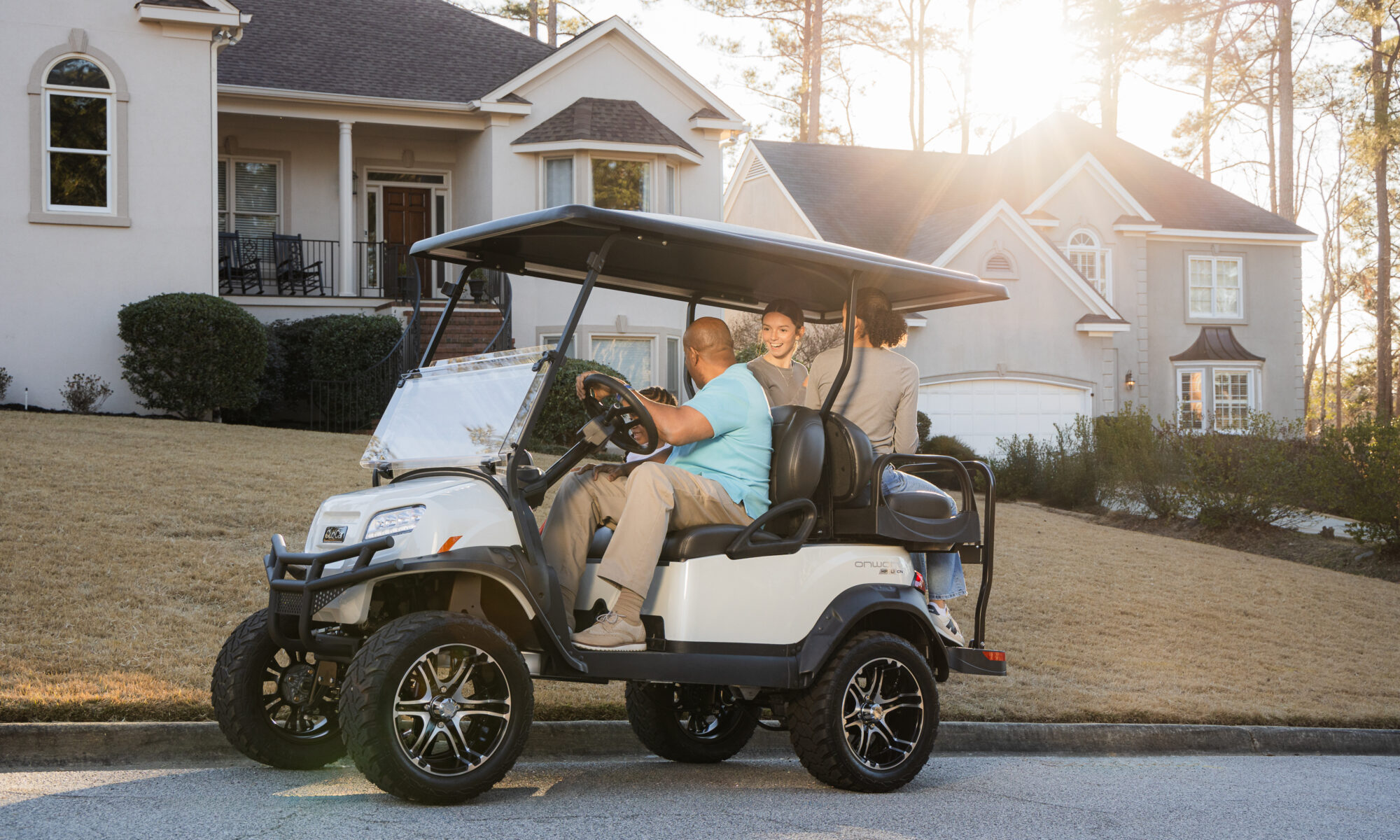 golf carts for sale in Venice FL featuring club car onward driving through a neighborhood with a sunny sky and white home.