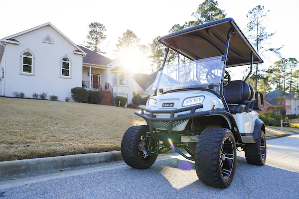 Club car onward on a street in a neighborhood. street legal golf carts near me.